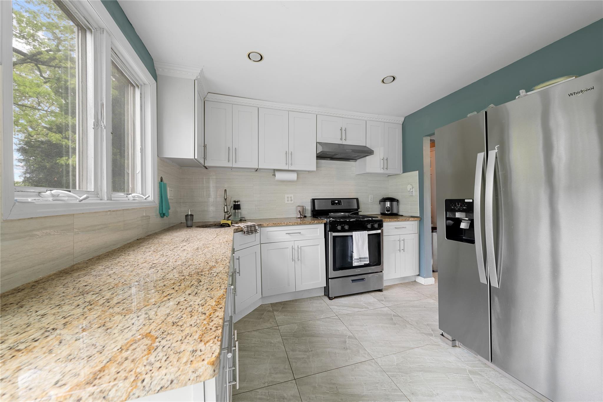 51 Joline Road Port Jefferson Station, NY 11776 - Photo 18 of 38 a kitchen with a refrigerator sink and stove