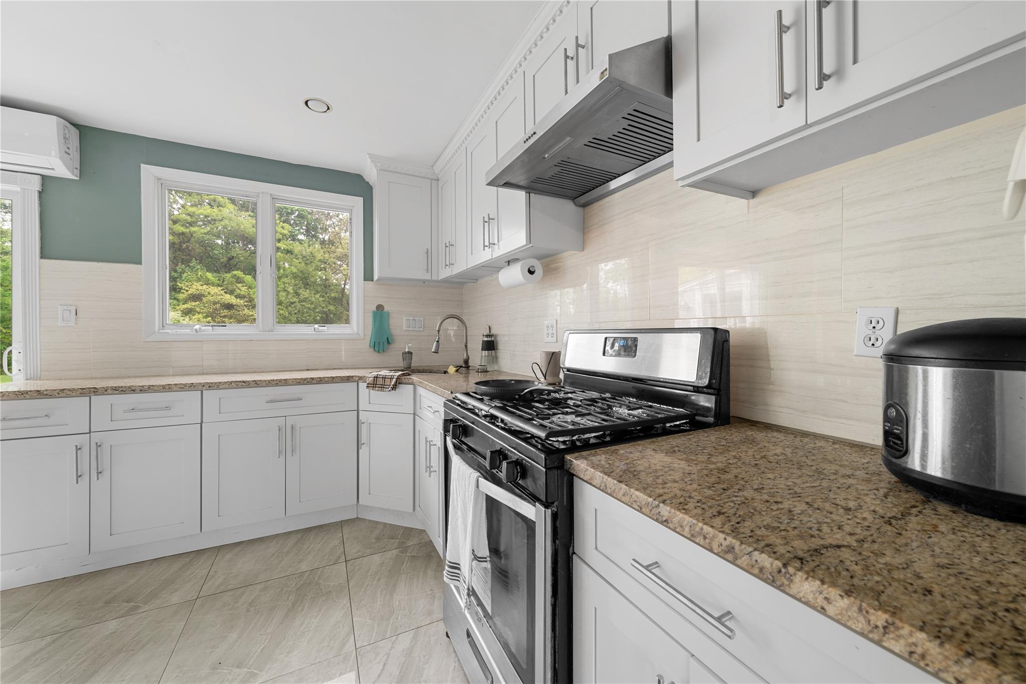 51 Joline Road Port Jefferson Station, NY 11776 - Photo 20 of 38 a kitchen with stainless steel appliances granite countertop a stove a sink dishwasher and refrigerator