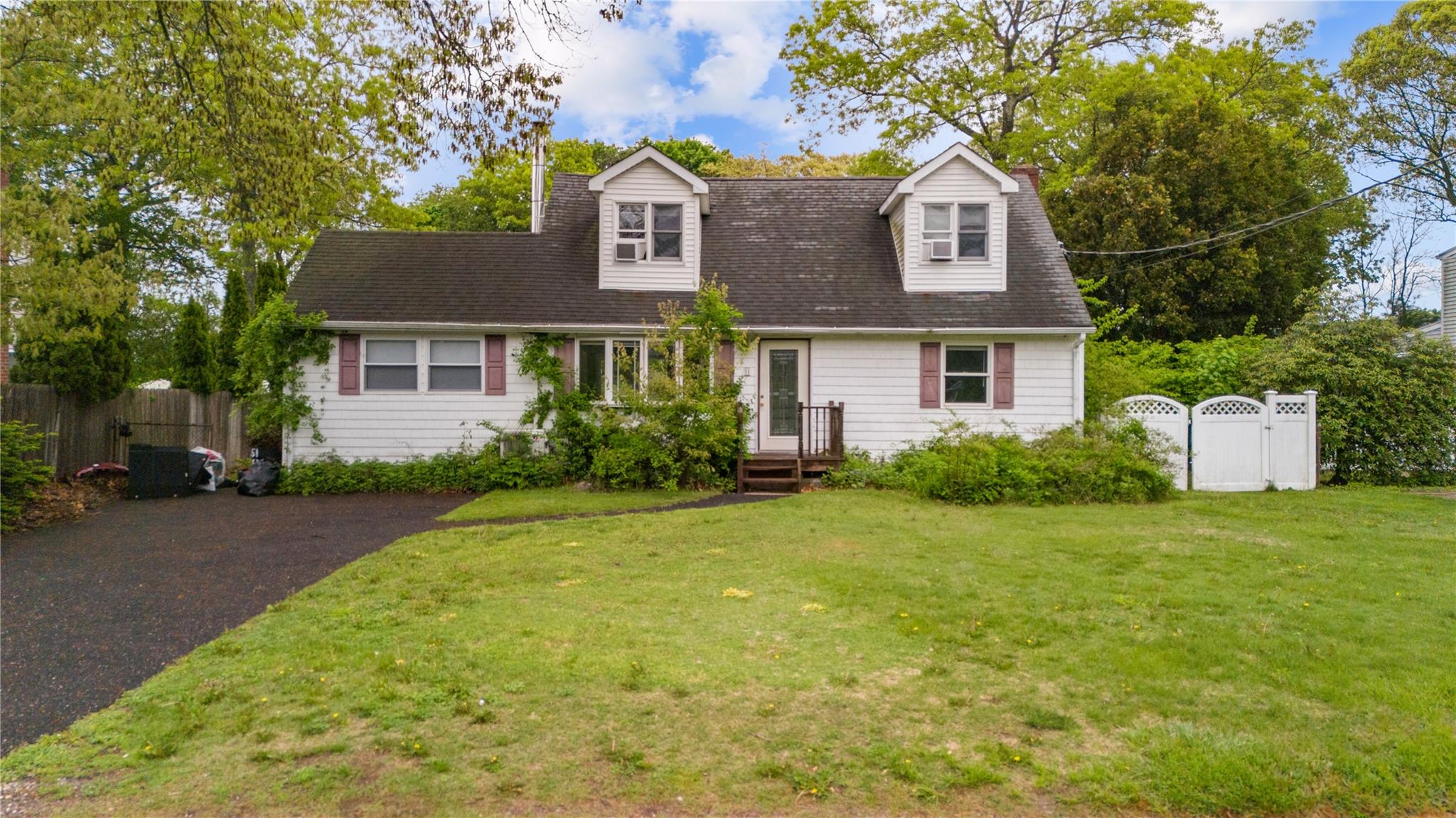 51 Joline Road Port Jefferson Station, NY 11776 - Photo 2 of 38 a front view of a house with a garden