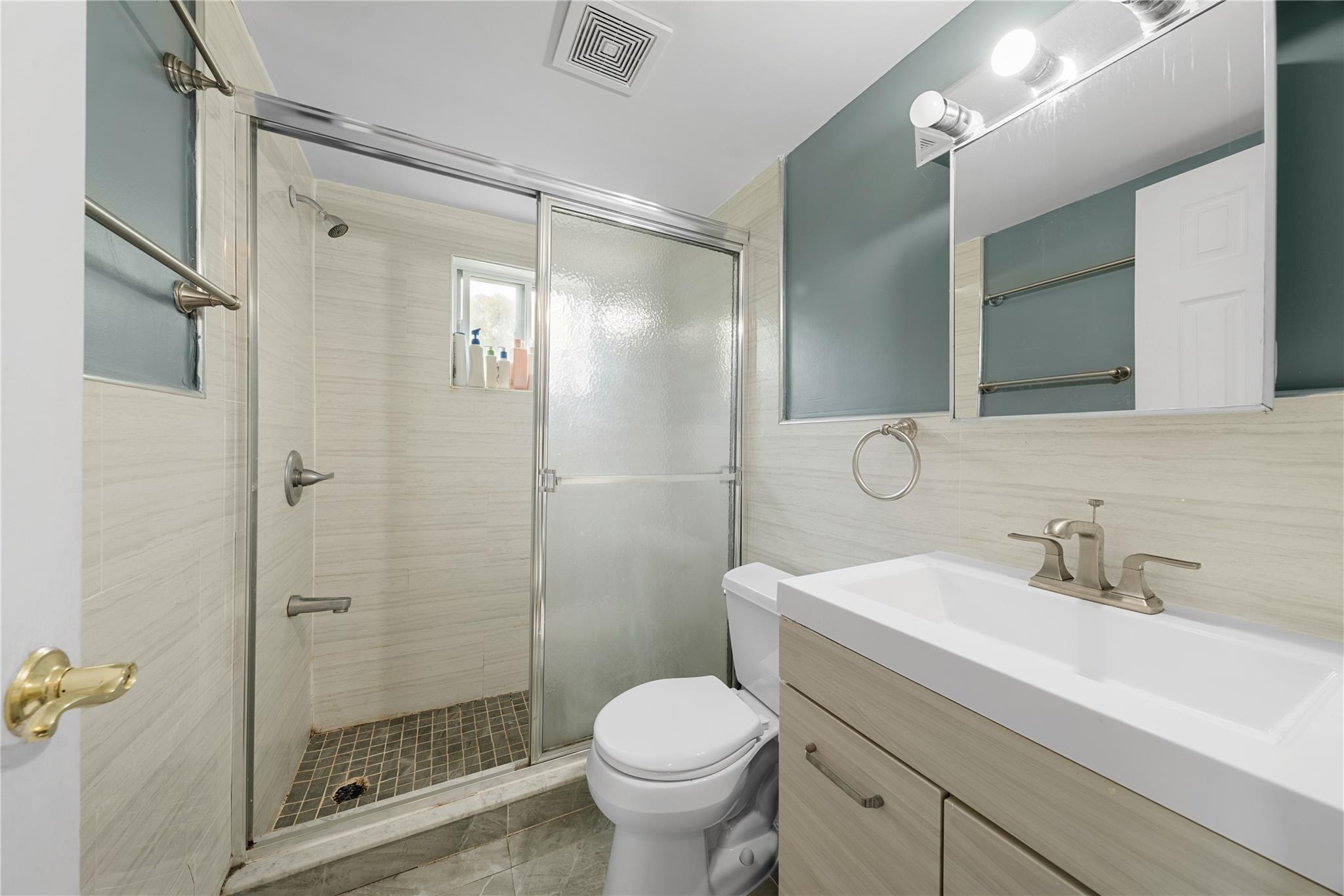 51 Joline Road Port Jefferson Station, NY 11776 - Photo 29 of 38 a bathroom with a shower sink vanity mirror and toilet