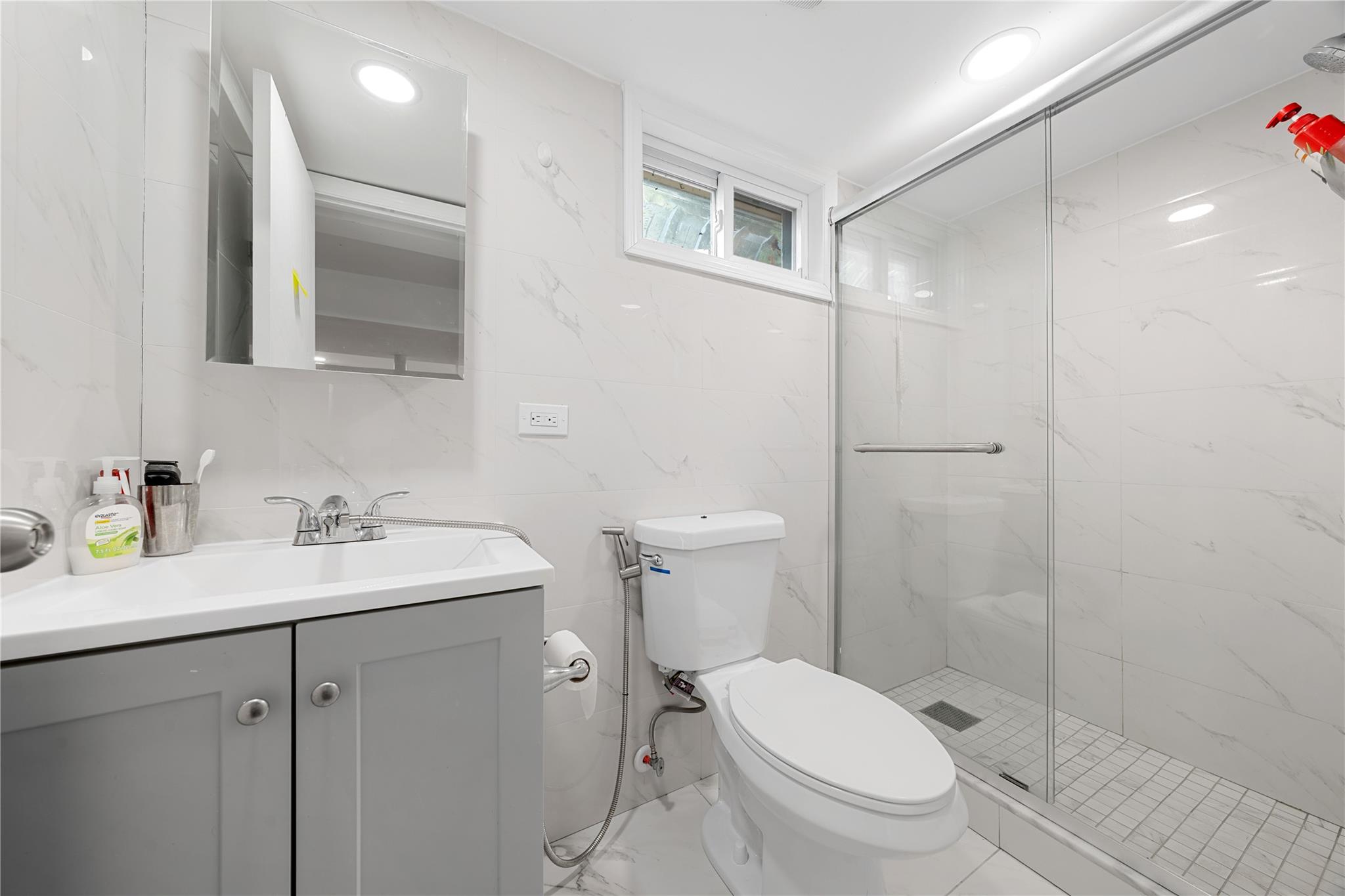 51 Joline Road Port Jefferson Station, NY 11776 - Photo 35 of 38 a bathroom with a toilet a sink a mirror a vanity and shower