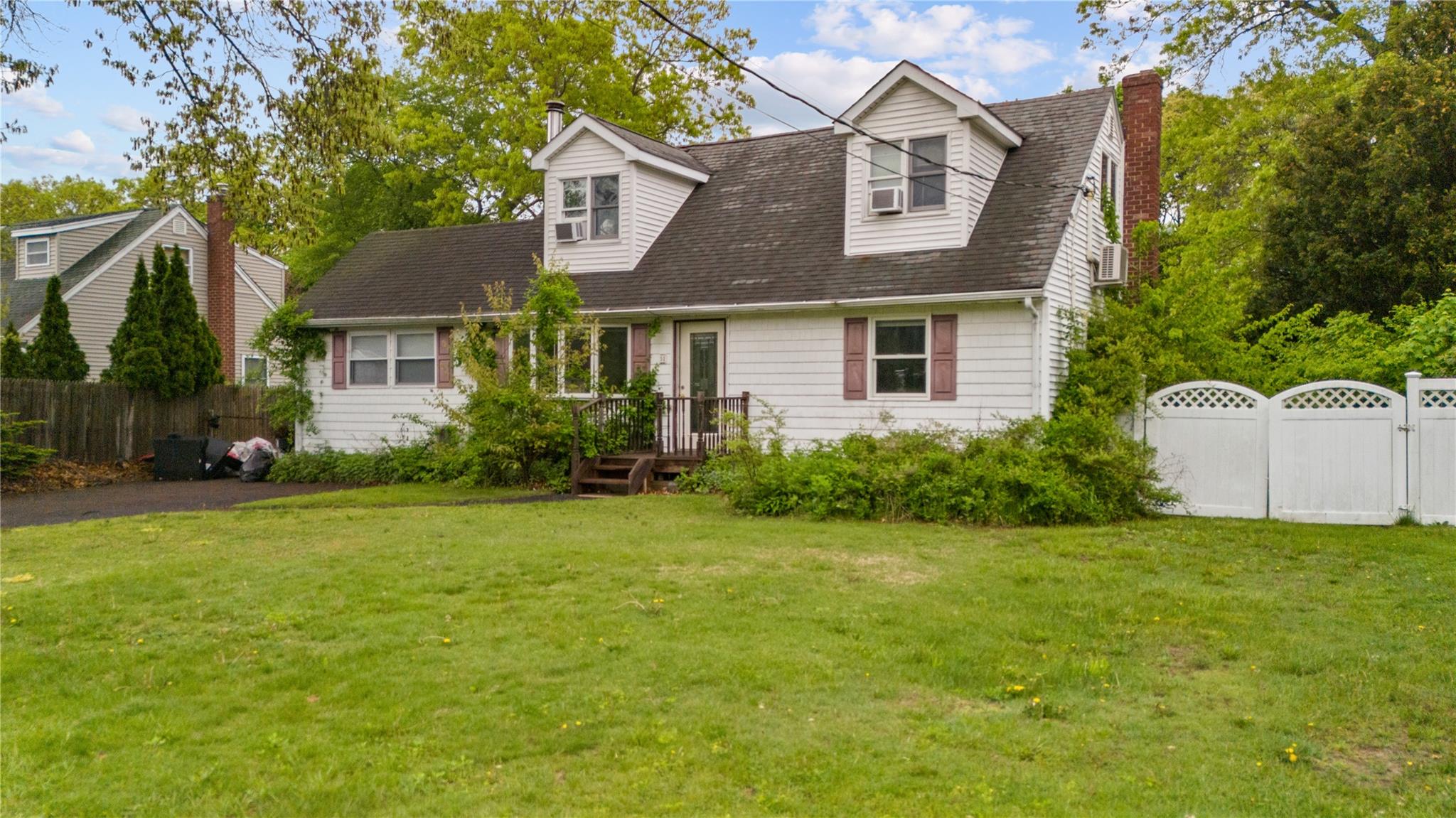 51 Joline Road Port Jefferson Station, NY 11776 - Photo 4 of 38 a front view of a house with a yard and garage
