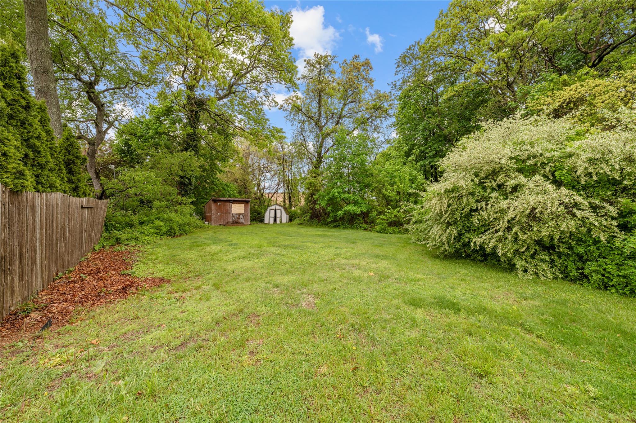 51 Joline Road Port Jefferson Station, NY 11776 - Photo 8 of 38 a view of a green field with trees in the background