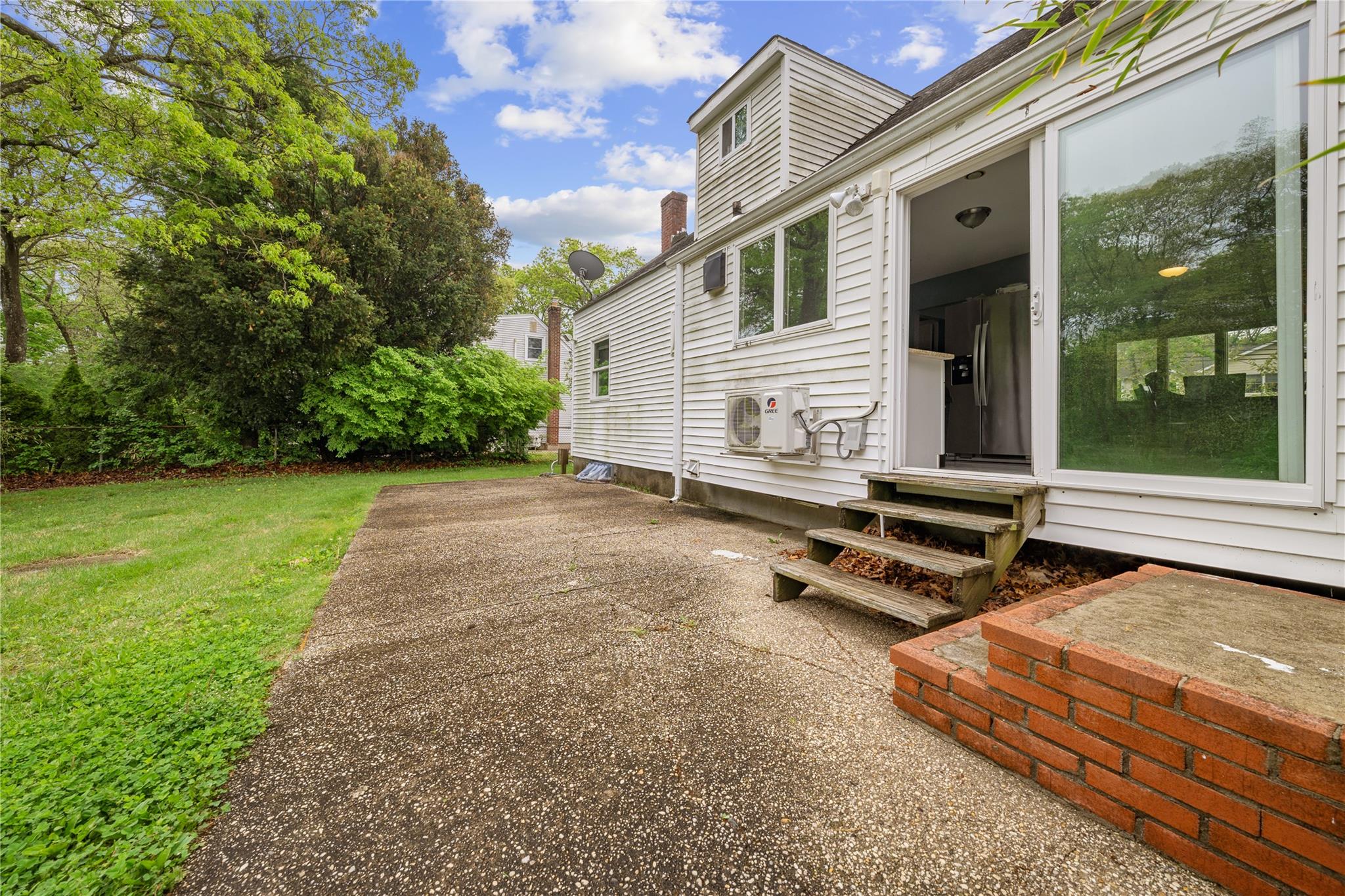 51 Joline Road Port Jefferson Station, NY 11776 - Photo 9 of 38 a backyard of a house with barbeque oven table and chairs