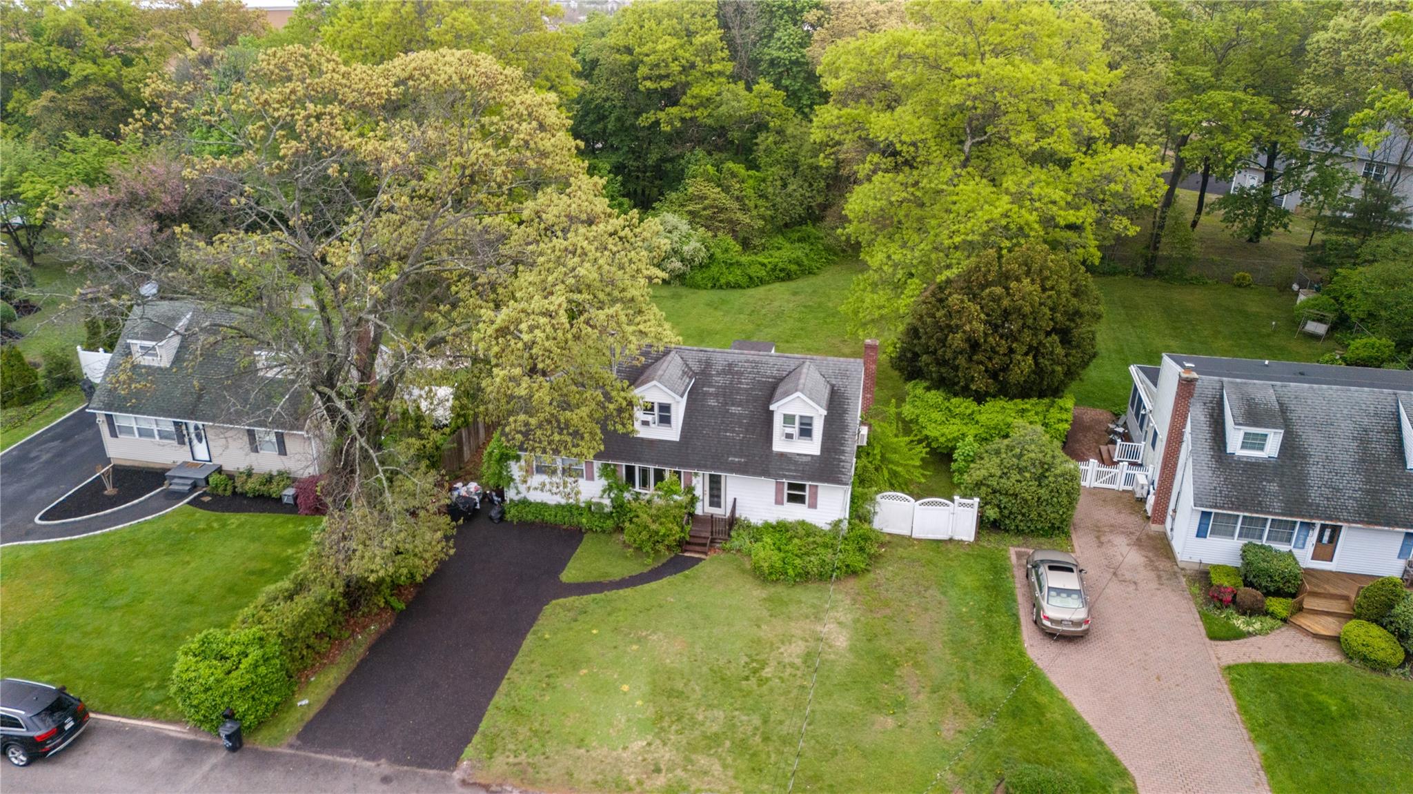 51 Joline Road Port Jefferson Station, NY 11776 - Photo 10 of 38 a aerial view of a house with a yard and large trees