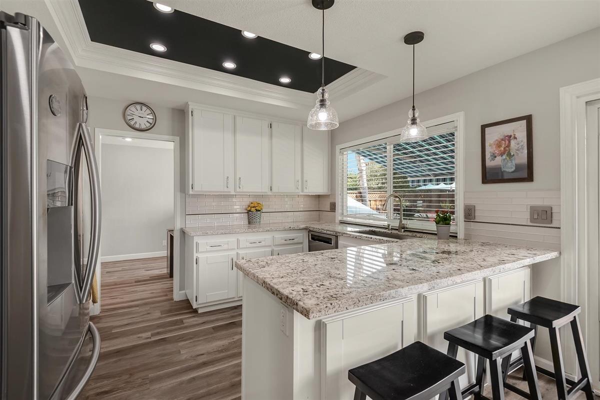 1428 Eagles Nest Lane Gilroy, CA 95020 - Photo 11 of 38 a kitchen with stainless steel appliances granite countertop a sink a refrigerator and a stove