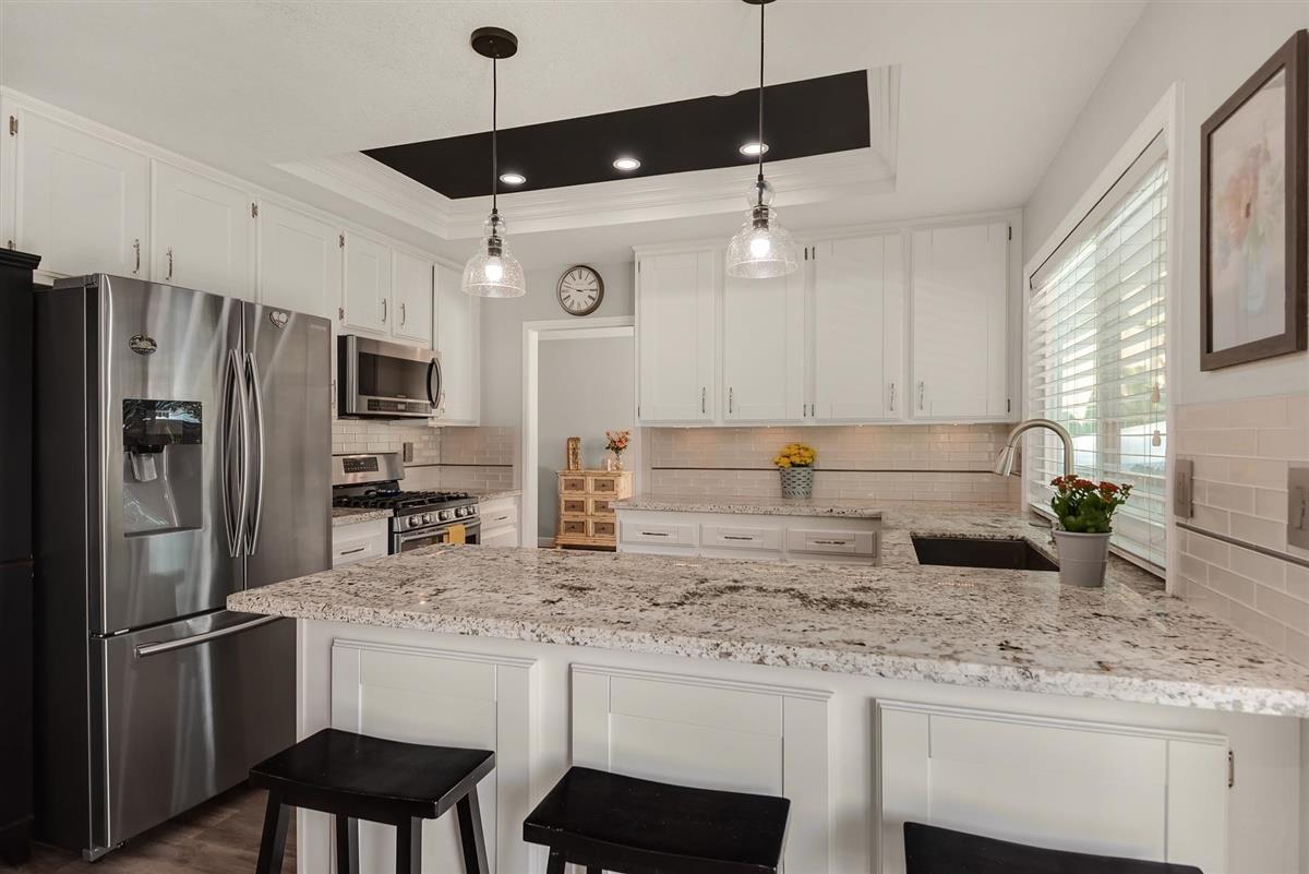 1428 Eagles Nest Lane Gilroy, CA 95020 - Photo 12 of 38 a kitchen with stainless steel appliances granite countertop a sink refrigerator and cabinets