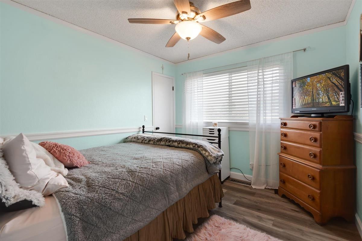 1428 Eagles Nest Lane Gilroy, CA 95020 - Photo 28 of 38 a bedroom with a bed and a flat screen tv