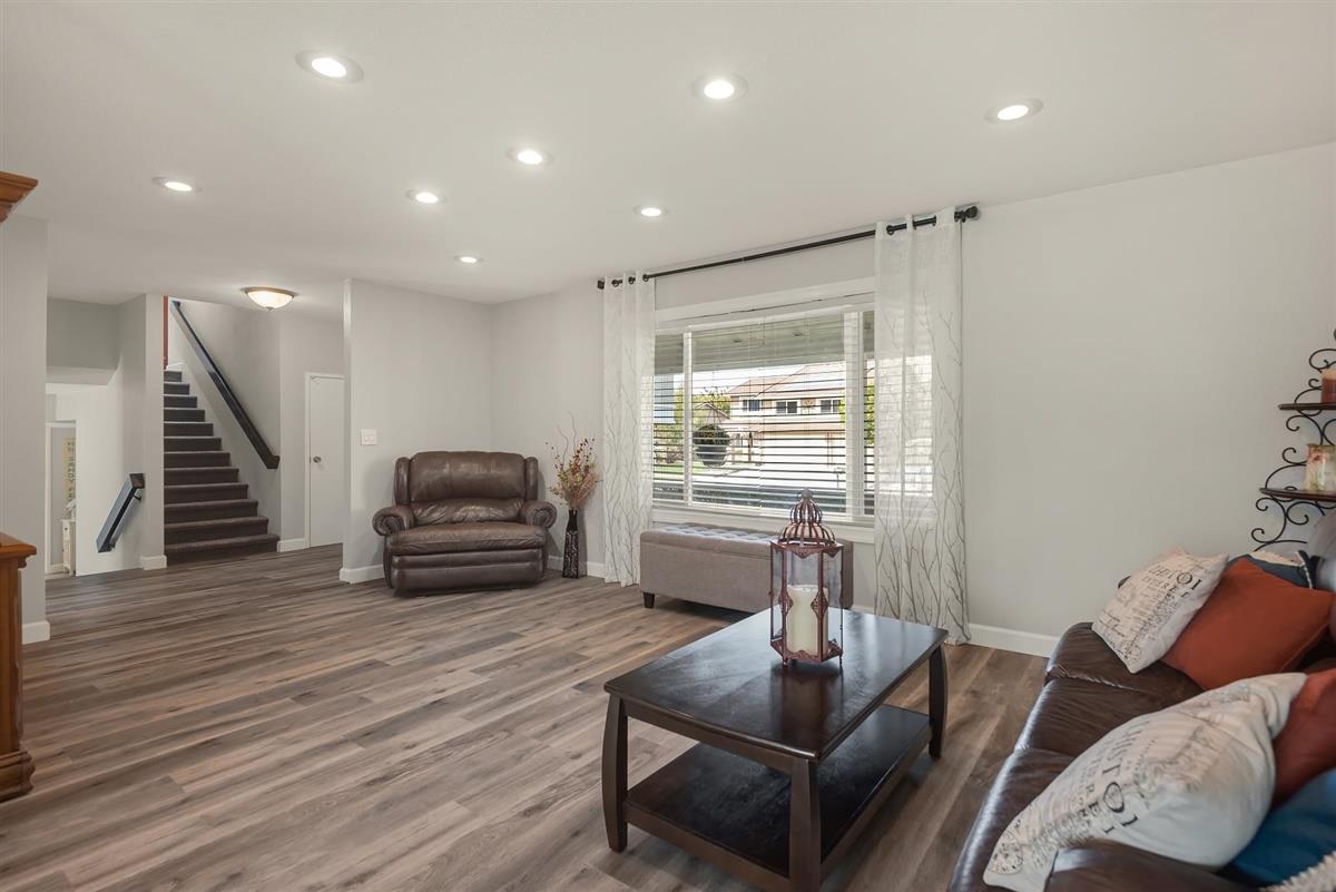 1428 Eagles Nest Lane Gilroy, CA 95020 - Photo 7 of 38 a living room with furniture and a wooden floor