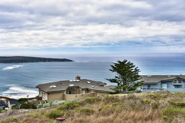 an aerial view of a house with a yard
