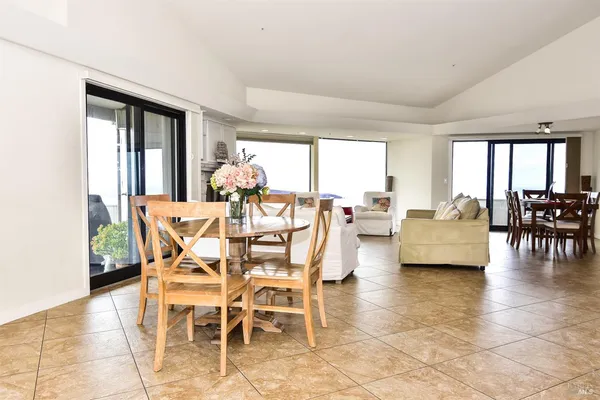 a dining room with furniture and a floor to ceiling window
