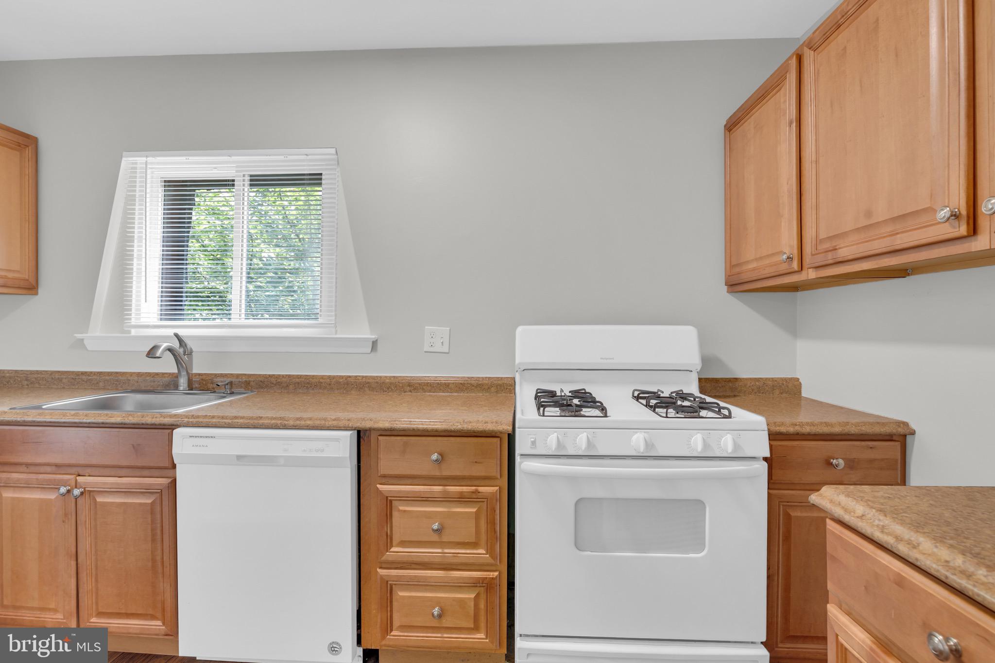 11620 Vantage Hill Road, Unit 22B Reston, VA 20190 - Photo 15 of 24 a kitchen with granite countertop a sink stove and cabinets
