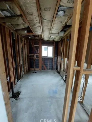 a view of empty room with wooden walls