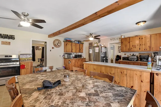 a large kitchen with kitchen island granite countertop a stove and a sink