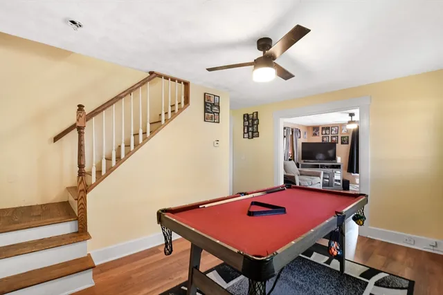 a view of a room with furniture and wooden floor