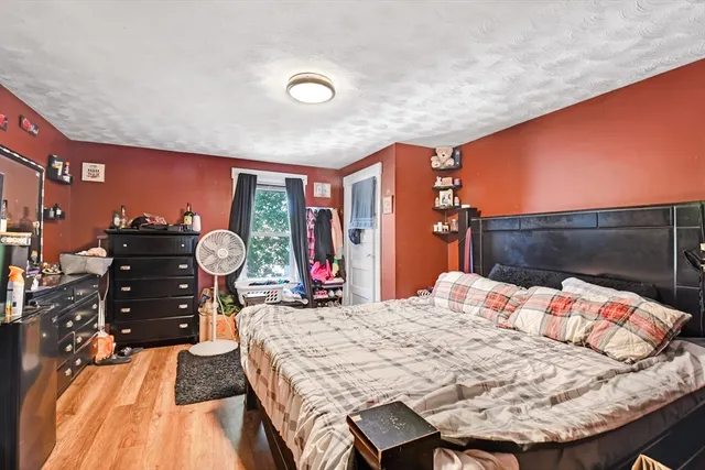 a bed sitting in a bedroom next to a window