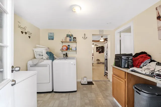 a storage room with cabinets washer and dryer