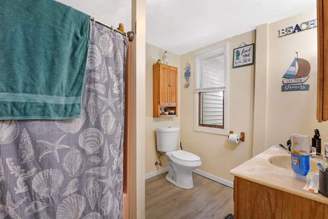 a bathroom with a sink toilet and shower