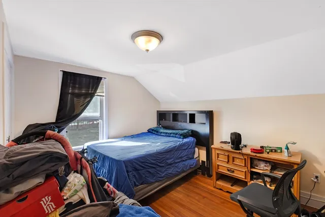 a bedroom with a bed and a dresser