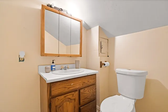 a bathroom with a toilet sink and mirror