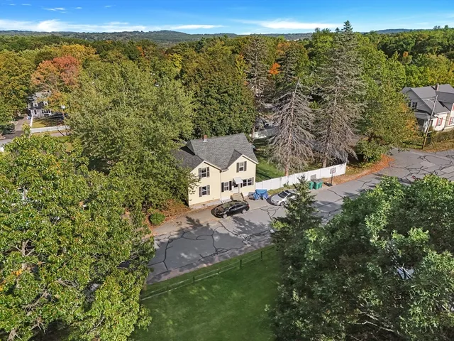 an aerial view of a house with a yard