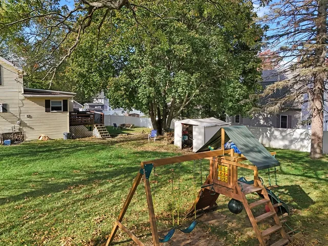 a view of a house with backyard and sitting area