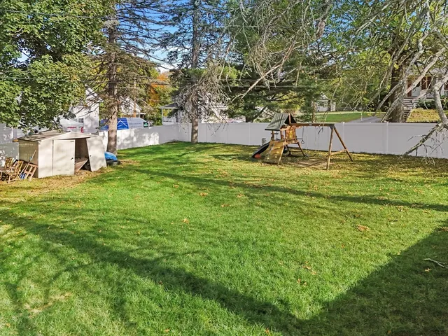 a view of a playground with a house and a park