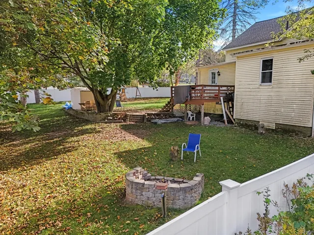 a wooden bench sitting in front of a house