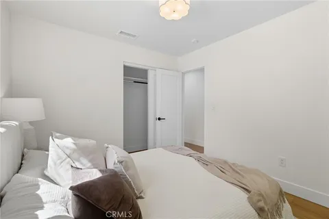 a bedroom with a bed and a lamp