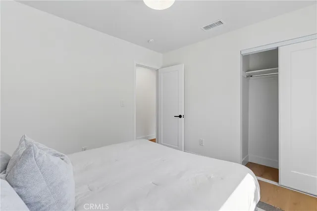 a bedroom with a bed and a mirror