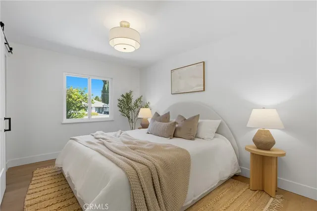 a bedroom with a bed and a painting on the wall