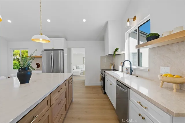 a kitchen with a sink and a refrigerator