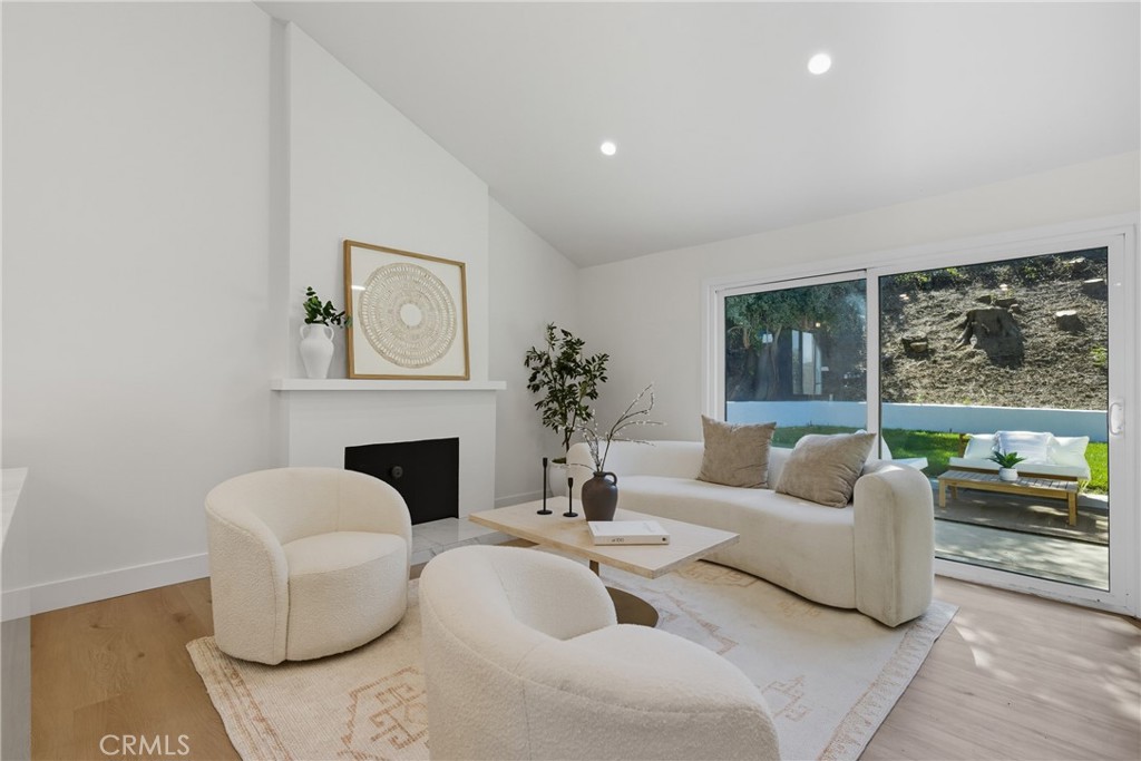 226 Tennyson Street Thousand Oaks, CA 91360 - Photo 7 of 27 a living room with furniture a fireplace and a large window