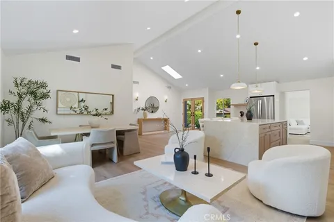 a living room with furniture kitchen and a table
