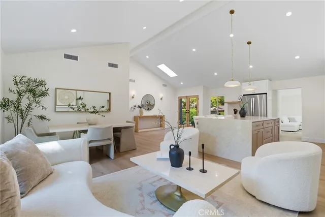 a living room with furniture kitchen and a table