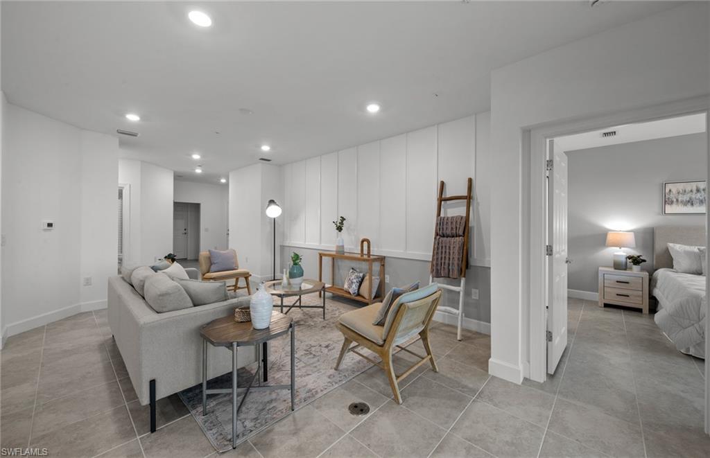 5693 Mayflower Way, Unit 1107 Ave Maria, FL 34142 - Photo 16 of 46 a living room with furniture and wooden floor