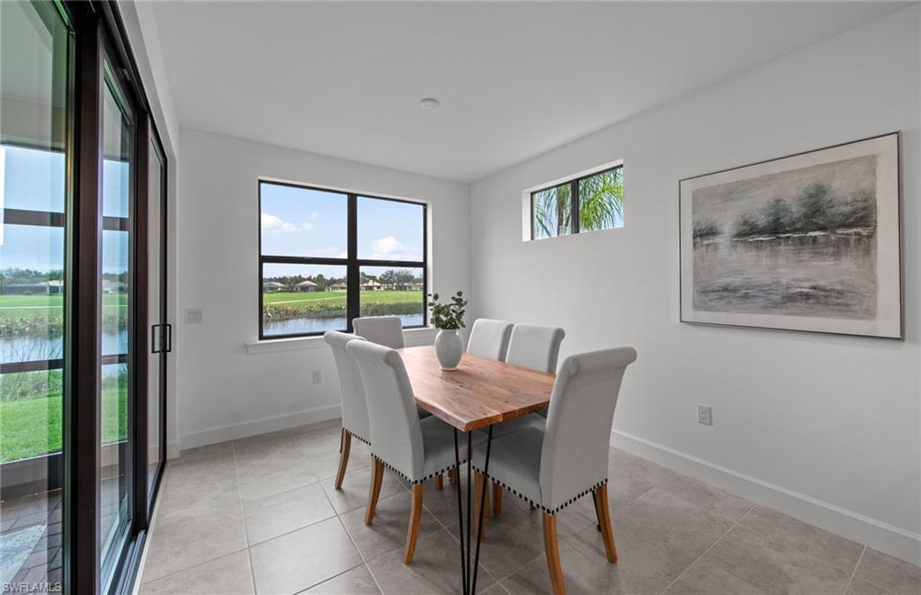 5693 Mayflower Way, Unit 1107 Ave Maria, FL 34142 - Photo 21 of 46 a view of a dining room with furniture window and outside view