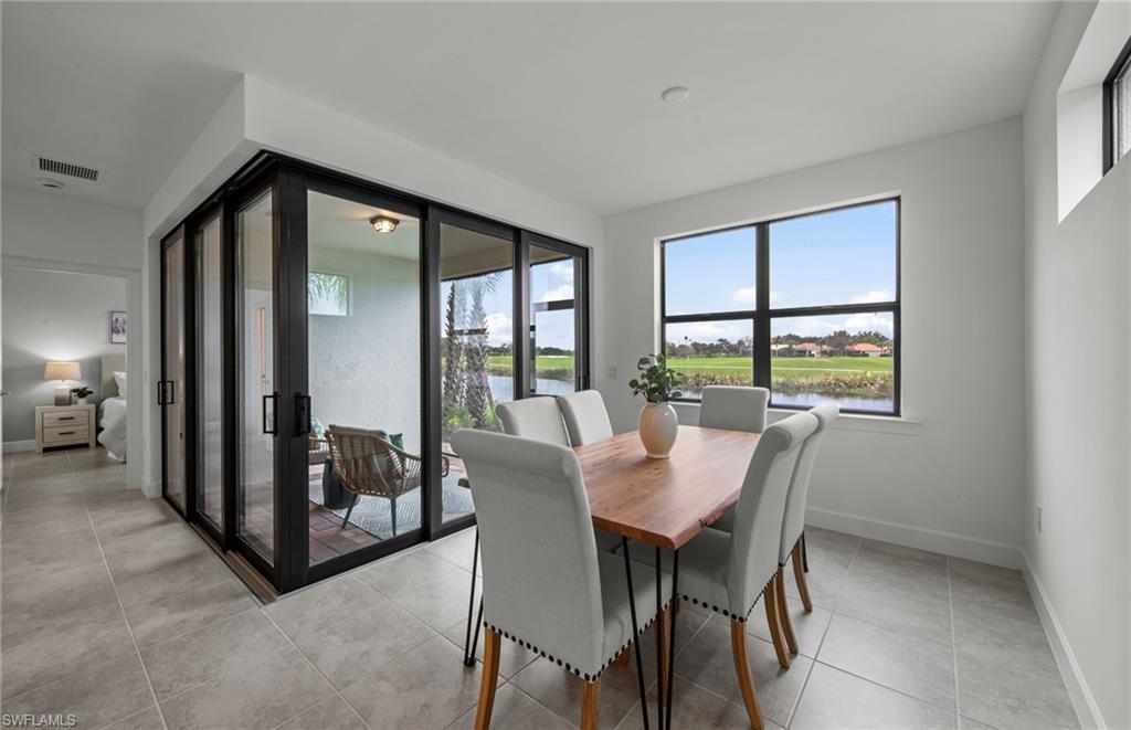 5693 Mayflower Way, Unit 1107 Ave Maria, FL 34142 - Photo 22 of 46 a view of a dining room with furniture window and outside view