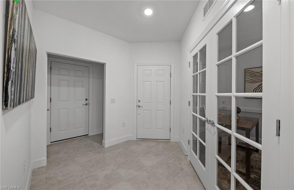 5693 Mayflower Way, Unit 1107 Ave Maria, FL 34142 - Photo 23 of 46 a view of a hallway with wooden floor and entryway