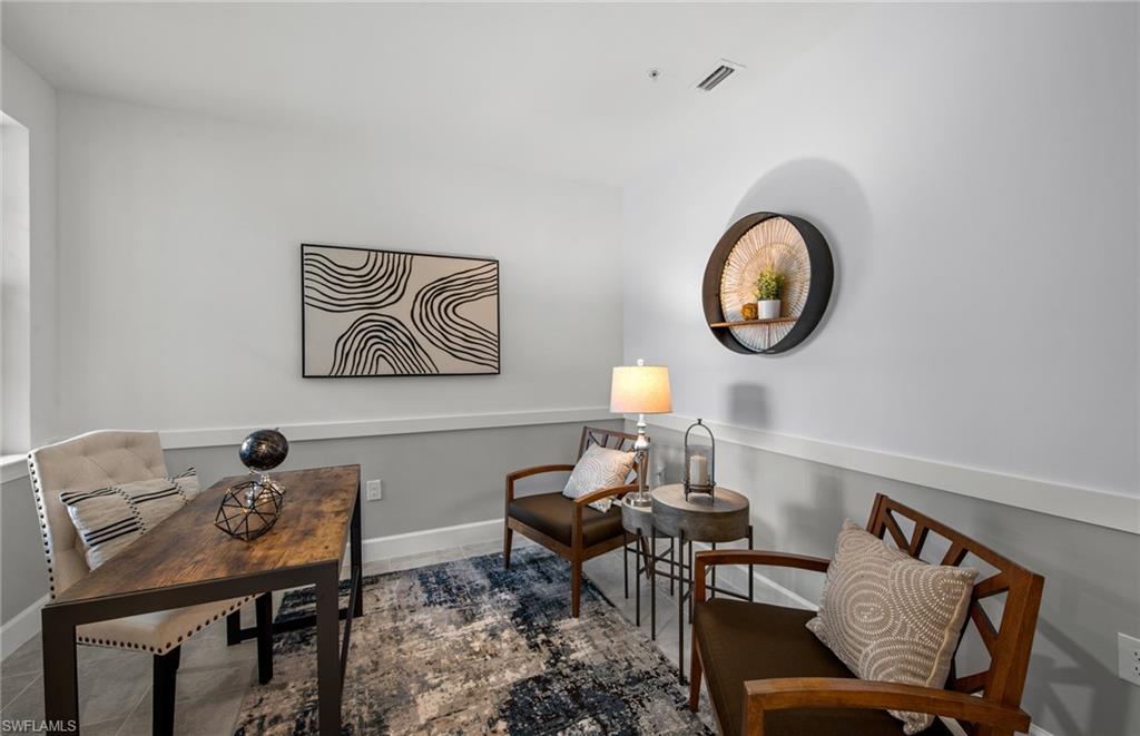 5693 Mayflower Way, Unit 1107 Ave Maria, FL 34142 - Photo 25 of 46 a view of a room that has a table and chairs