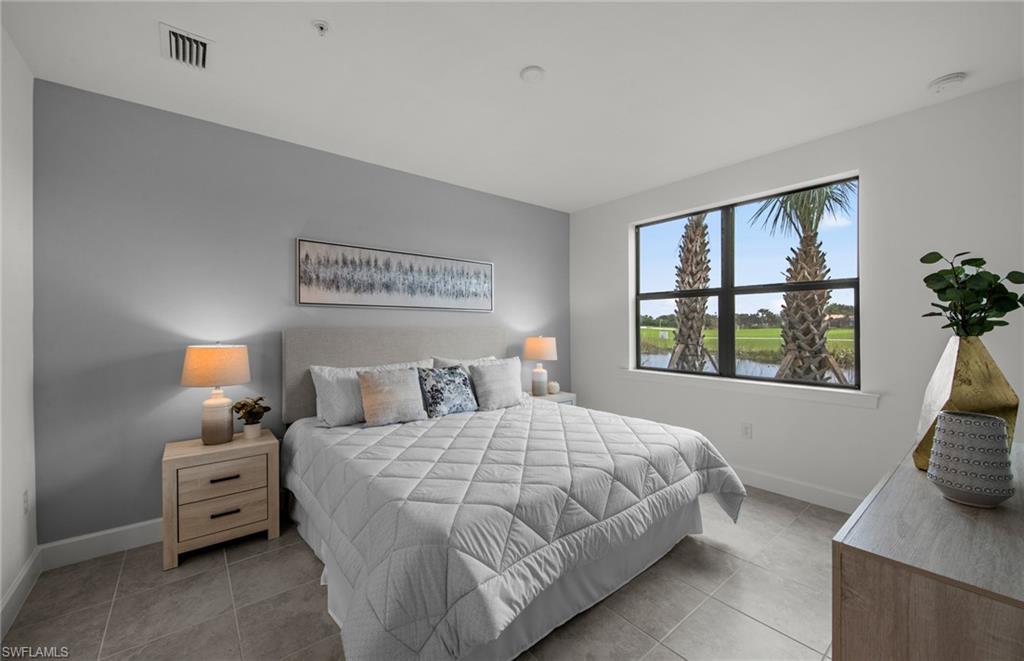 5693 Mayflower Way, Unit 1107 Ave Maria, FL 34142 - Photo 26 of 46 a bedroom with a bed and a window