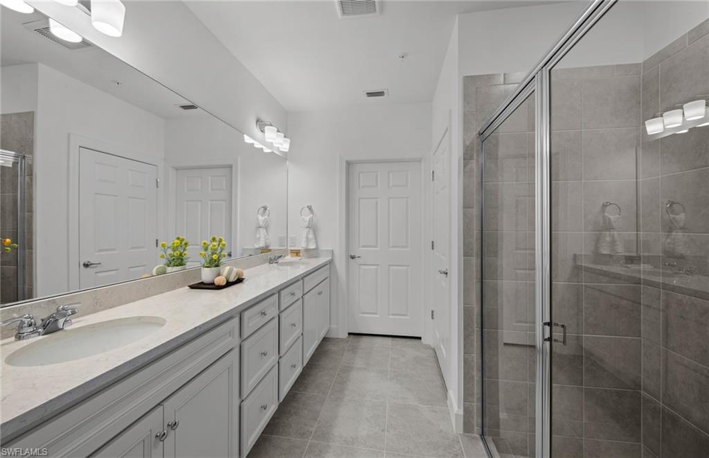 5693 Mayflower Way, Unit 1107 Ave Maria, FL 34142 - Photo 28 of 46 a spacious bathroom with a double vanity sink mirror and shower