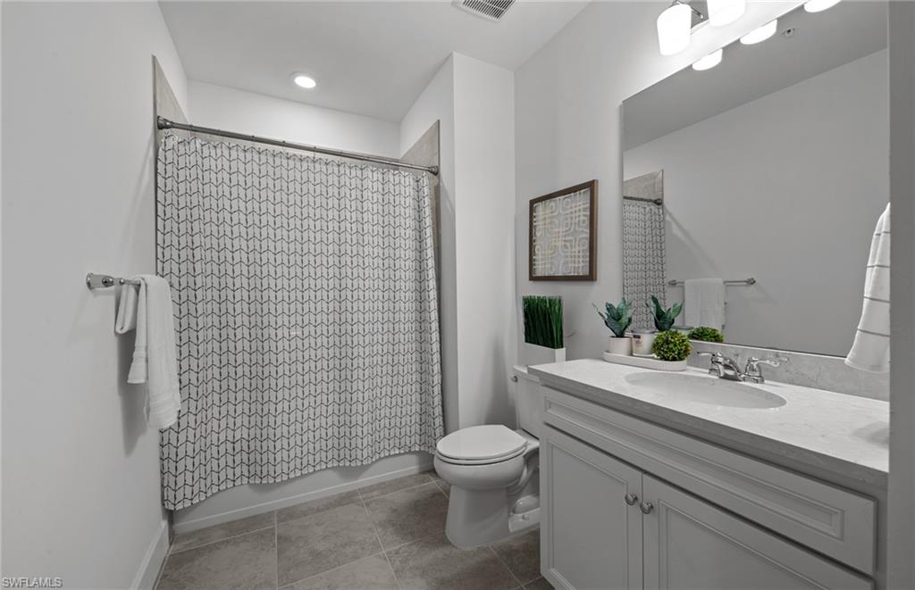5693 Mayflower Way, Unit 1107 Ave Maria, FL 34142 - Photo 32 of 46 a bathroom with a sink a toilet and shower