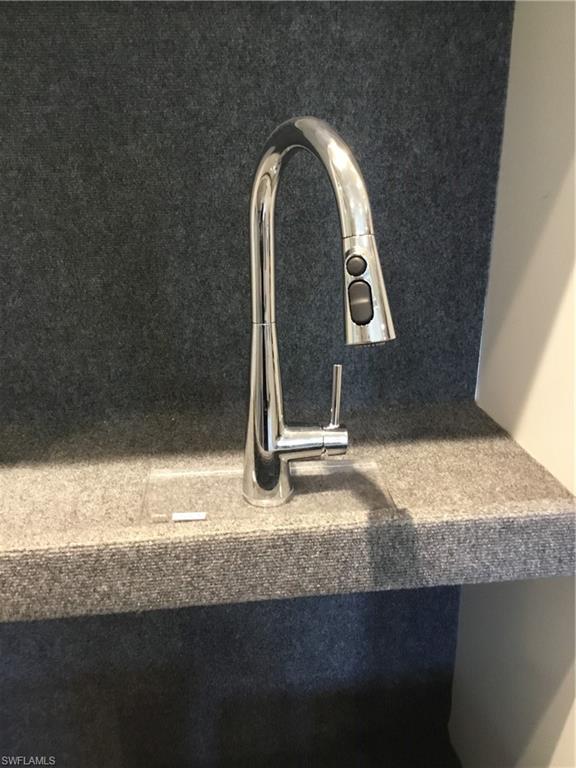 5693 Mayflower Way, Unit 1107 Ave Maria, FL 34142 - Photo 7 of 46 a view of a livingroom dresser and a floor to ceiling window