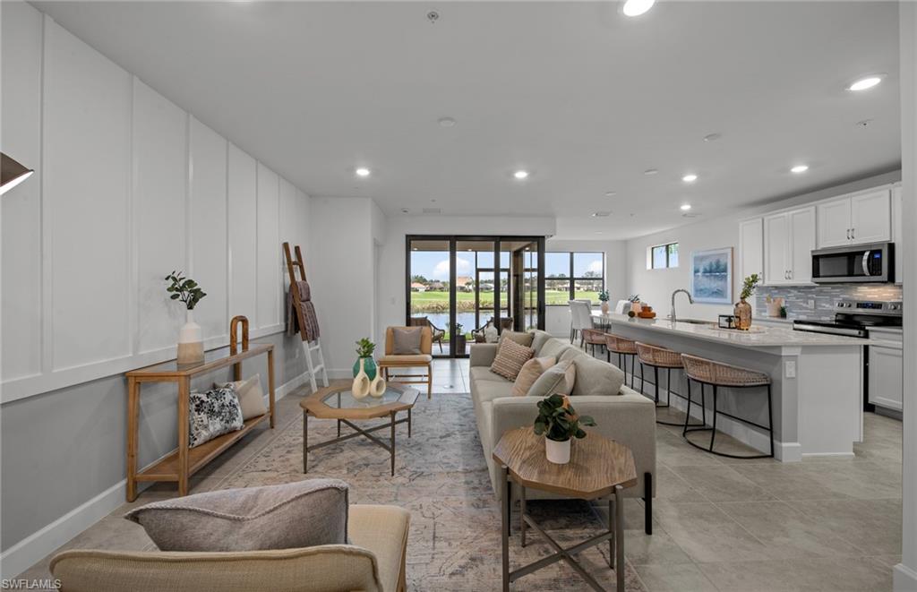 5693 Mayflower Way, Unit 1107 Ave Maria, FL 34142 - Photo 10 of 46 a living room with furniture and a wooden floor