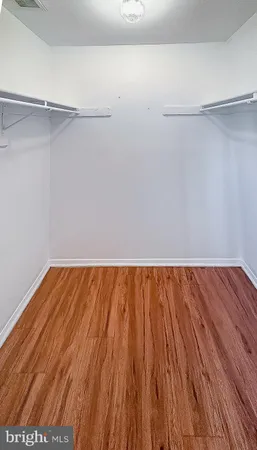 a bed sitting in a bedroom next to a bathroom