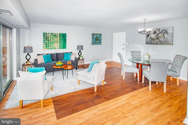 a dining room with wooden floor and glass door