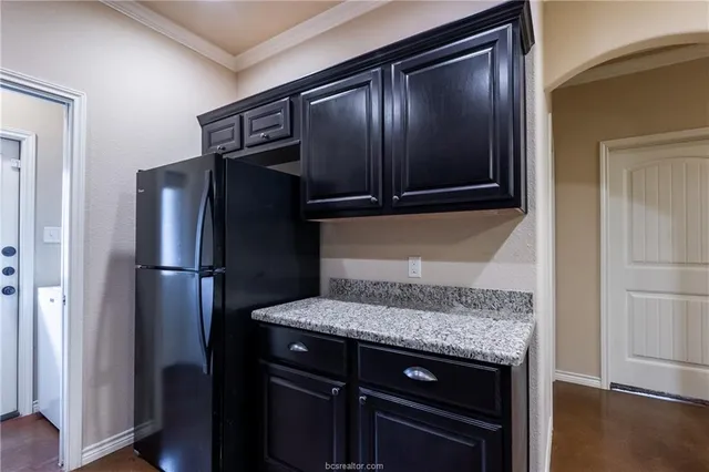 a kitchen with a refrigerator and a sink