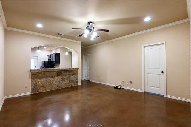 a view of a room with a faucet and ceiling fan