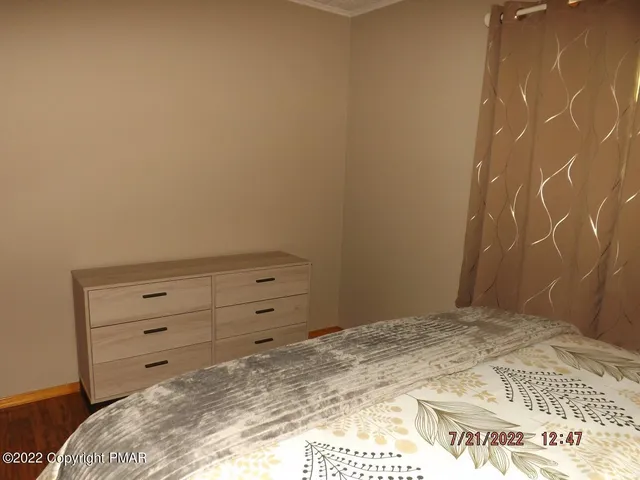 a bedroom with a bed and a dresser